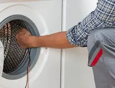Dryer repair technician diagnosing and servicing a clothes dryer in Houston, TX