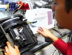 Vacuum repair technician servicing internal components on a workbench in Houston, TX