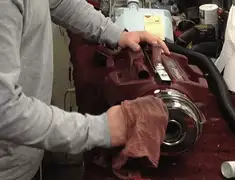 Vacuum repair technician cleaning and servicing a vacuum motor in Houston, TX